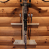 Wall-mounted crossbow rack with arrow storage and installed on the wall.