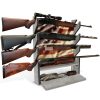 Gray wood rifle wall rack with American flag panel and accessory storage shelf.