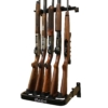 Gun wall rack with five rifles secured in protective holders.