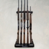 Five rifles stored on a wall-mounted gun rack with adjustable holders.
